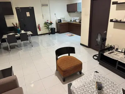 a living room with a chair and a kitchen at KLCC Pavilion 127 Alor Street Ceylon KL Bukit Bintang 5 Pax in Kuala Lumpur