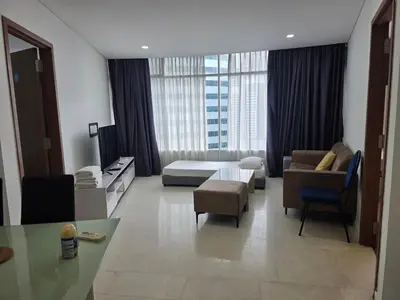 a hotel room with a bed and a table and chairs at Vortex suites klcc by musab in Kuala Lumpur