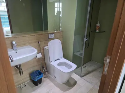 a bathroom with a toilet and a sink and a shower at Vortex suites klcc by musab in Kuala Lumpur