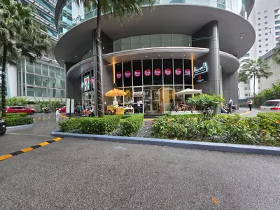 a large building with a restaurant in front of it at Vortex suites klcc by musab in Kuala Lumpur