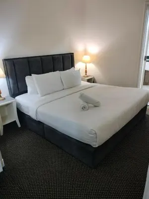a large bed with a laptop on top of it at Night suite apartment at time square kl in Kuala Lumpur