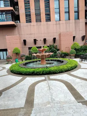 a fountain in a courtyard in front of a building at Night suite apartment at time square kl in Kuala Lumpur