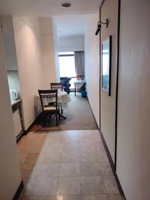 a hallway leading to a living room with a table at Night suite apartment at time square kl in Kuala Lumpur