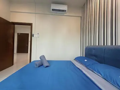 a bedroom with a blue bed with blue pillows at Spacious Family 2BR Balcony Comfy Regalia Suites in Kuala Lumpur
