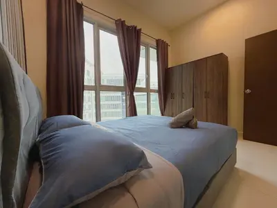 a bedroom with a bed with a large window at Spacious Family 2BR Balcony Comfy Regalia Suites in Kuala Lumpur