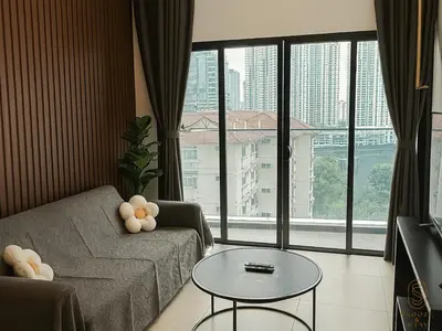 a living room with a couch and a table at Family Suites Reizz Ampang 2R2B in Kuala Lumpur