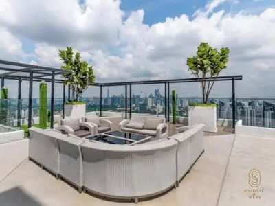 a patio with a table and chairs on a balcony at Family Suites Reizz Ampang 2R2B in Kuala Lumpur