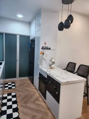 a kitchen with a counter and some chairs in it at Yasemin Homestay in Kuala Lumpur