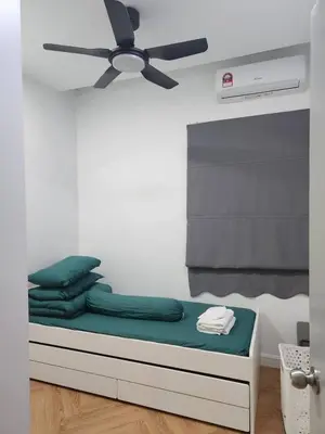a room with a bed with a ceiling fan at Yasemin Homestay in Kuala Lumpur