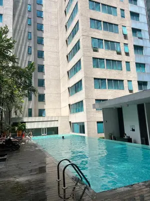 a large swimming pool in front of a building at Mercu summer suits 1BR luxury couple room free Netflix 5mint WD KLCC by Top R in Kuala Lumpur