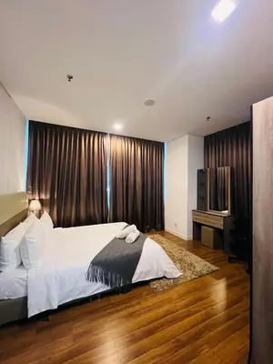 a bedroom with a large bed and a television at Mercu summer suits 1BR luxury couple room free Netflix 5mint WD KLCC by Top R in Kuala Lumpur