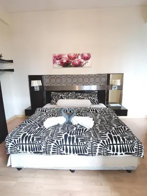 a bedroom with a bed with a black and white comforter at Seri Bukit Ceylon in Kuala Lumpur