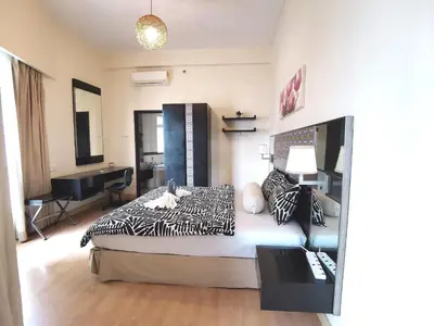a bedroom with a bed and a desk in it at Seri Bukit Ceylon in Kuala Lumpur