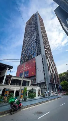 a motorcycle parked in front of a tall building at Scarletz Suite KLCC 2 in Kuala Lumpur