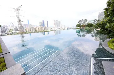 a pool of water with a city in the background at Stylish M Vertica 3 Bedroom Walk to MRT Velocity Mall in Kuala Lumpur