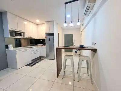 a kitchen with a table and stools in it at Studio in Kuala Lumpur