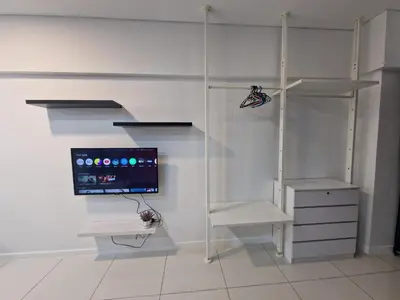 a white room with a computer monitor and shelves at Studio in Kuala Lumpur