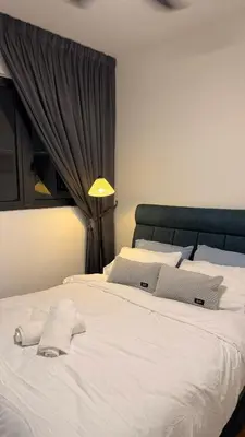 a large white bed with two towels on it at M Vertica KL Cheras Velocity KLCC View in Kuala Lumpur
