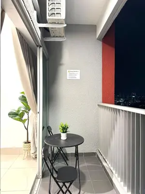 a balcony with a table and two chairs on it at 2BR unit in Razak City Residence by Lisa Homestay in Kuala Lumpur