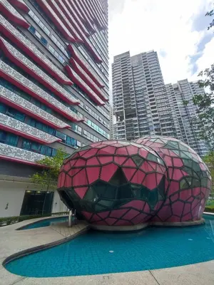a building with a sculpture in the middle of a city at Comfy Room in High Floor! in Kuala Lumpur