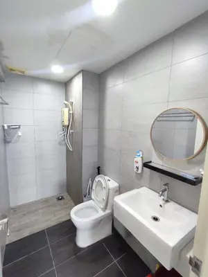 a bathroom with a toilet and a sink and a mirror at Comfy Room in High Floor! in Kuala Lumpur