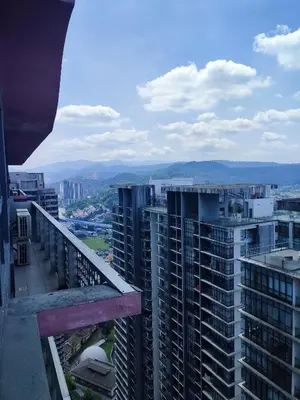 a view of a city from the balcony of a building at Comfy Room in High Floor! in Kuala Lumpur