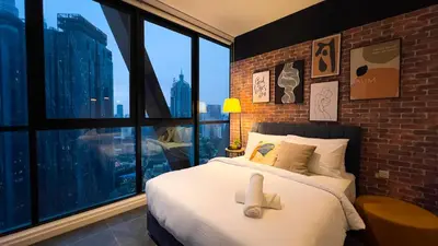 a bedroom with a bed with a teddy bear on it at Scarletz Suite KLCC By Light House 4 in Kuala Lumpur