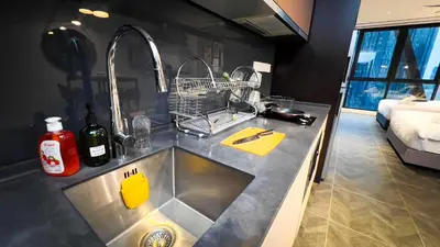 a kitchen sink with two faucets on a counter at Scarletz Suite KLCC By Light House 4 in Kuala Lumpur