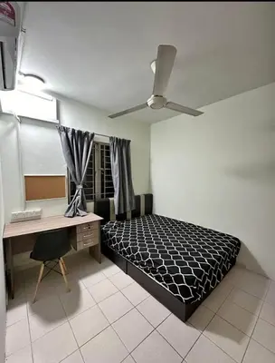 a bedroom with a bed and a desk and a ceiling fan at Flora Residency Setapak in Kuala Lumpur