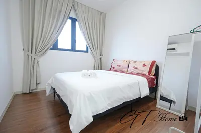 a bedroom with a bed with white sheets and a window at Gt home-Kuala Lumpur View 3Bedroom 2Bathroom in Kuala Lumpur