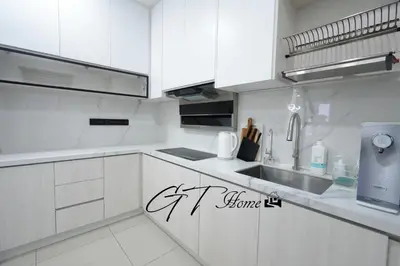 a white kitchen with white cabinets and a sink at Gt home-Kuala Lumpur View 3Bedroom 2Bathroom in Kuala Lumpur