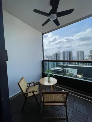 a balcony with a table and chairs and a ceiling fan at Arcoris SOHO Mont Kiara 2B2B, Home Stay in Kuala Lumpur