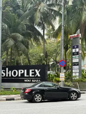 a black car parked in front of a sign at Arcoris SOHO Mont Kiara 2B2B, Home Stay in Kuala Lumpur