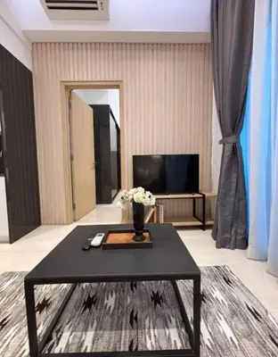 a living room with a table with flowers on it at The Colony By Infinitum L in Kuala Lumpur