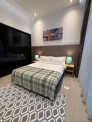 a bedroom with a large bed and a rug at The Colony By Infinitum L in Kuala Lumpur