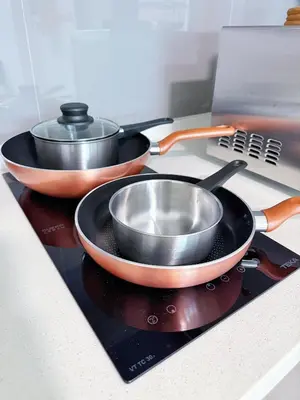 two pans sitting on top of a stove at Agile Delima Bukit Bintang in Kuala Lumpur