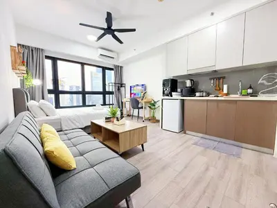 a living room with a couch and a kitchen at Agile Delima Bukit Bintang in Kuala Lumpur