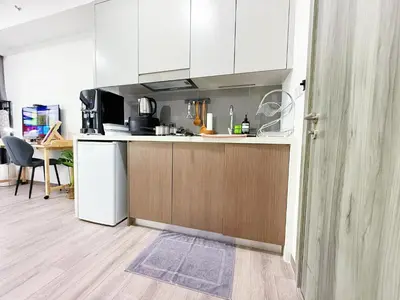 a kitchen with white cabinets and a counter top at Agile Delima Bukit Bintang in Kuala Lumpur