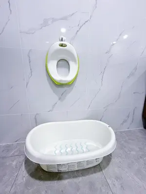 a white toilet in a bathroom with a urinal at Agile Delima Bukit Bintang in Kuala Lumpur