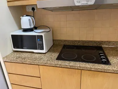 a microwave sitting on top of a kitchen counter at Kuala lampur city centre in Kuala Lumpur