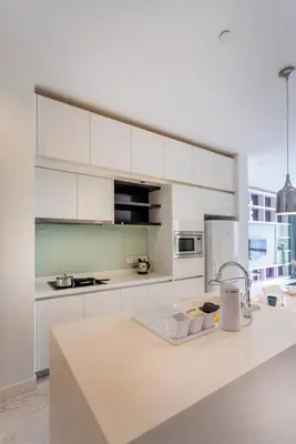 a kitchen with white cabinets and a white counter top at Platinum 2km to KLCC Kuala Lumpur in Kuala Lumpur