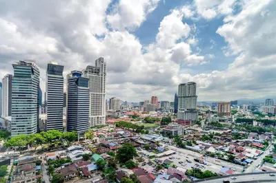 a city with tall skyscrapers and cars at Platinum 2km to KLCC Kuala Lumpur in Kuala Lumpur