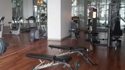 a gym with several treadmills and exercise bikes at Regalia residence suite view in Kuala Lumpur