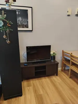 a living room with a table with a flat screen tv at Regalia residence suite view in Kuala Lumpur