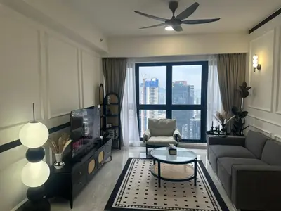 a living room with a couch and a large window at Agile Residence Near TRX in Kuala Lumpur