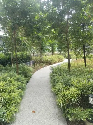 a walking path in a park with trees and grass at Agile Residence Near TRX in Kuala Lumpur