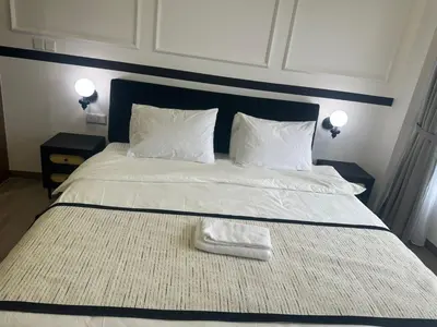 a bed with a white blanket and two pillows at Agile Residence Near TRX in Kuala Lumpur