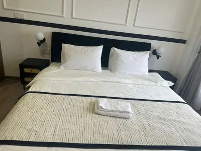a large white bed with two towels on it at Agile Residence Near TRX in Kuala Lumpur