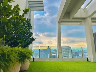 a view from the balcony of a building with green grass at Agile Residence Near TRX in Kuala Lumpur
