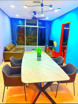 a dining room with a table and chairs and a couch at Luxury Home Stay by FNF suites in Kuala Lumpur